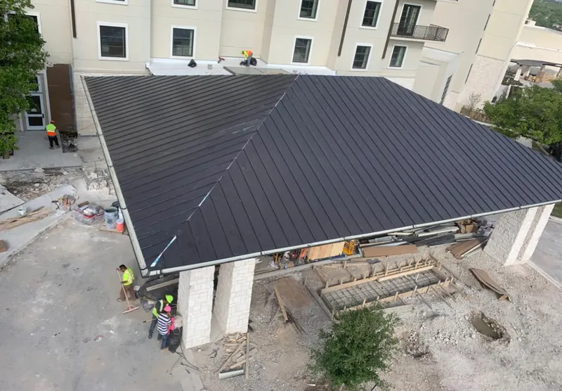 Metal roofing installation team working on a commercial building in Marathon