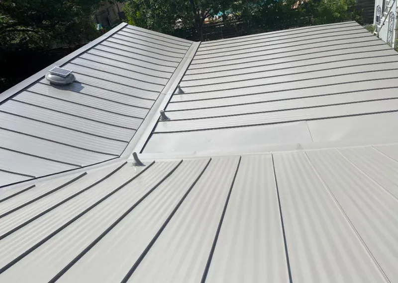 Solar attic fan installed on a metal roof for Roof Ventilation in Marathon